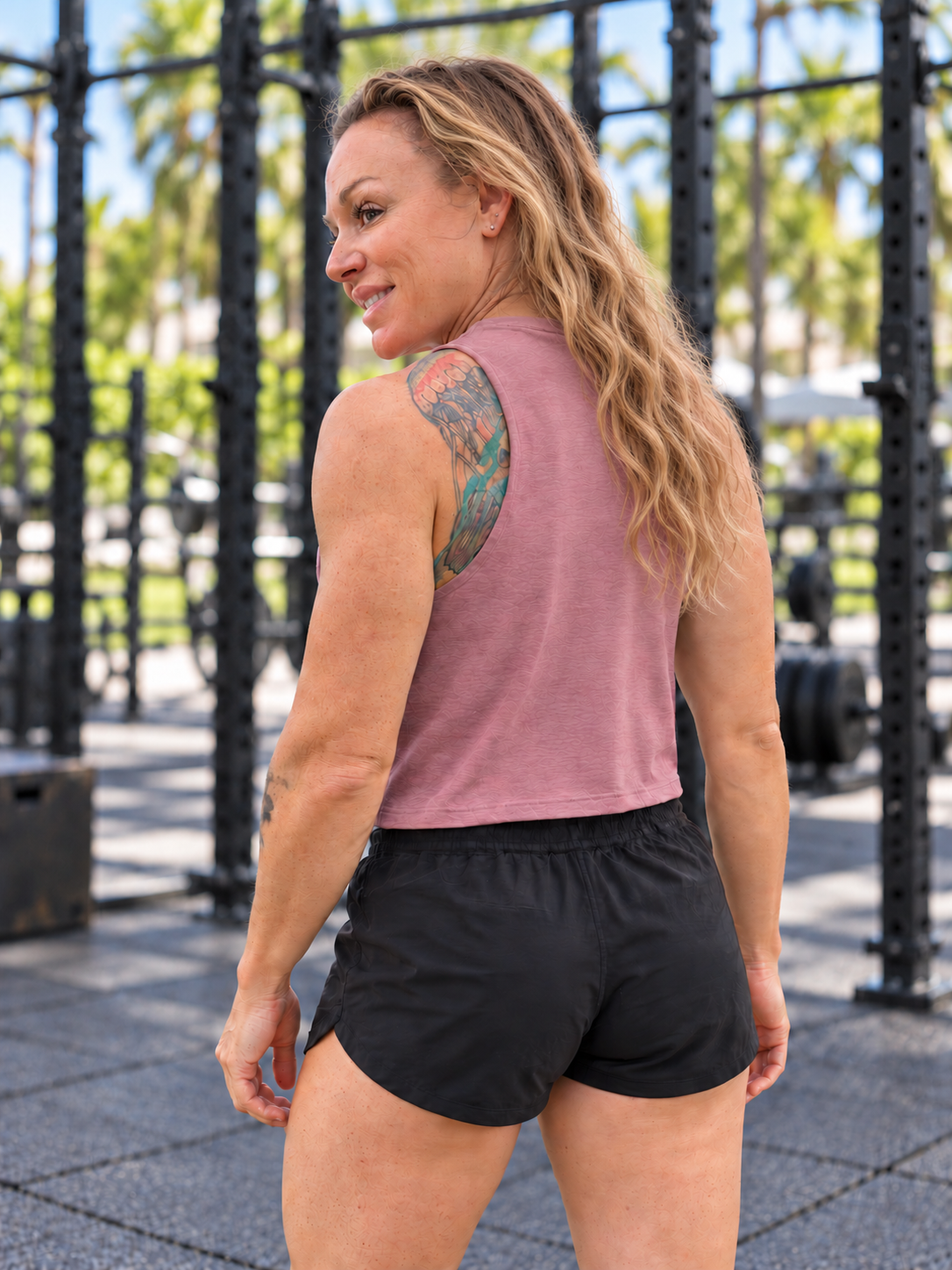 Meg wearing the Be a Golden Heather Mauve crop tank — back view with hair down