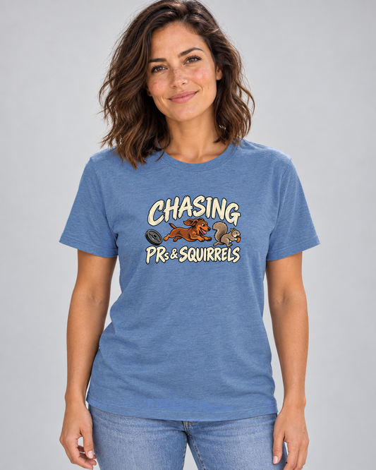Woman wearing Chasing PRs and Squirrels Everyday T in Heather Columbia Blue